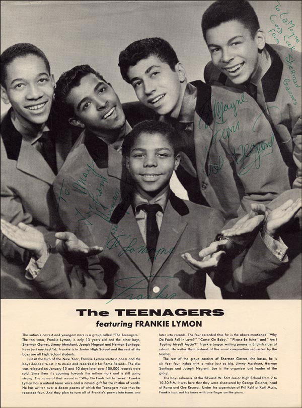 Black-and-white promotional photograph of the five members of Frankie Lymon and the Teenagers, taken around 1956. Four of the group, all teenagers in jackets and ties, stand in a tight cluster looking down and smiling broadly; thirteen-year-old Frankie Lymon, shorter than the others, is positioned in front and center, looking straight at the camera. The white margin around the photo carries signed greetings from each member to fans named LaMayne and Mary. Printed text at the bottom of the page identifies the group, lists the members, and gives a short biographical paragraph.