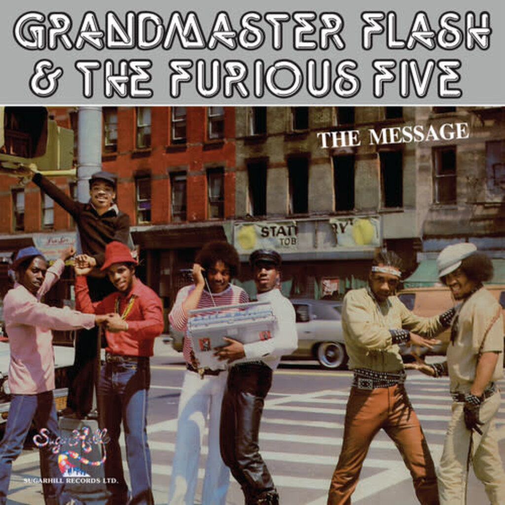 The cover of the 1982 Sugar Hill Records single "The Message," with the band name in graffiti-style lettering across the top. Below, seven young Black men pose on a South Bronx street: one perched on a streetlight pole, one in a red porkpie hat, one holding a large boombox, others in leather and denim, with a tenement and a stationery store storefront behind them.